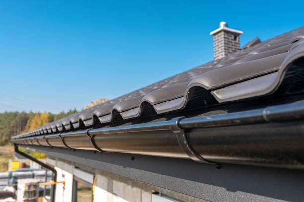 Long run of dark half-round gutter under a tile roof edge